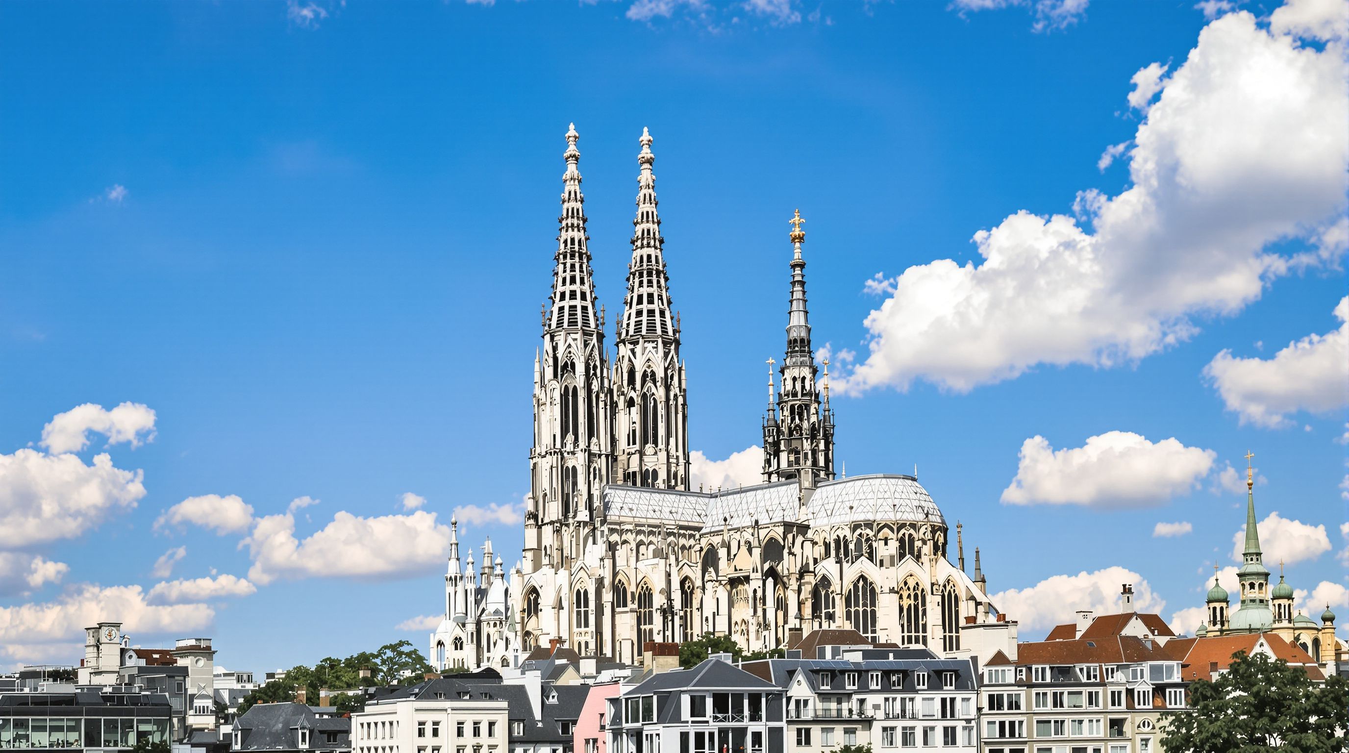 The iconic Cologne Cathedral under a clear blue sky.