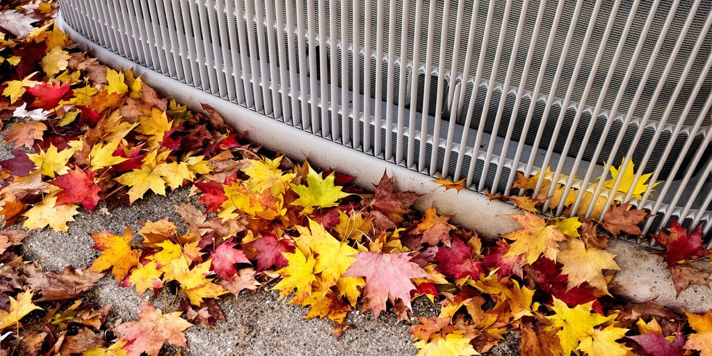 Warm autumn leaves near an outdoor HVAC unit.
