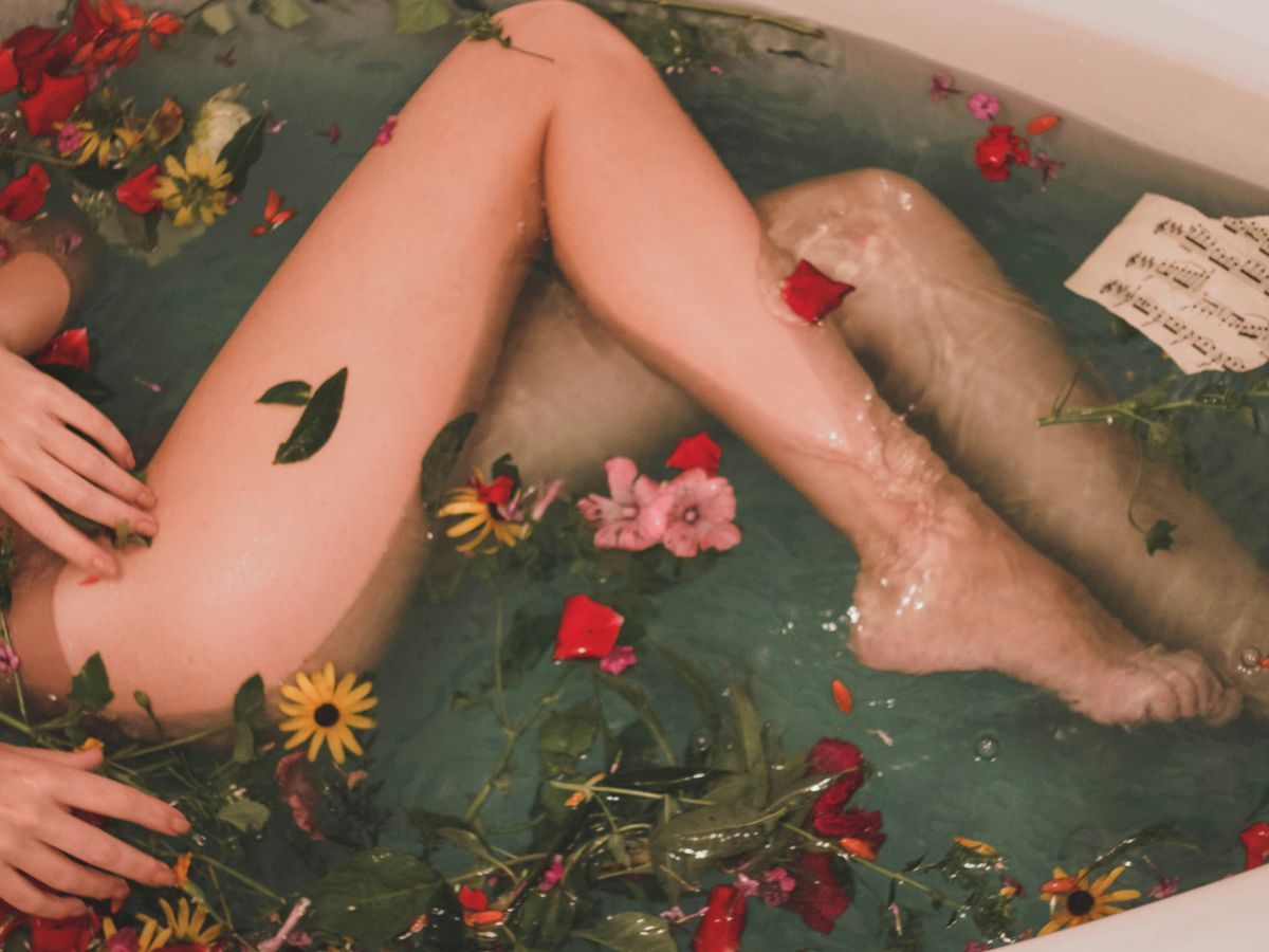 bathtub with water and flowers