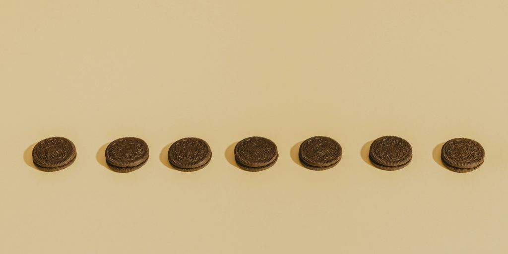 eight round gold coins on white surface