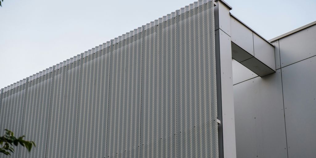 a building that has a metal structure on top of it