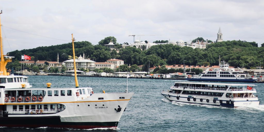 white and black boat on sea during daytime