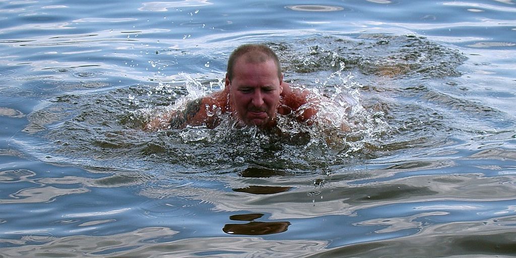 swimmer drinking recovery drink poolside