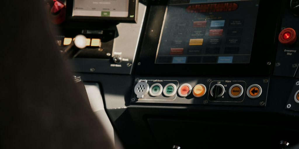 A person sitting in a vehicle with a control panel