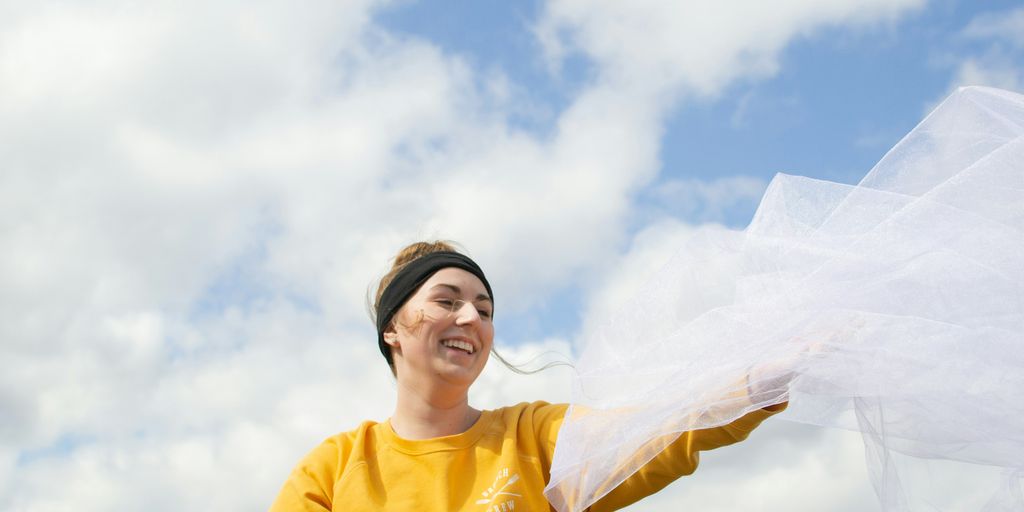 woman holding white veil