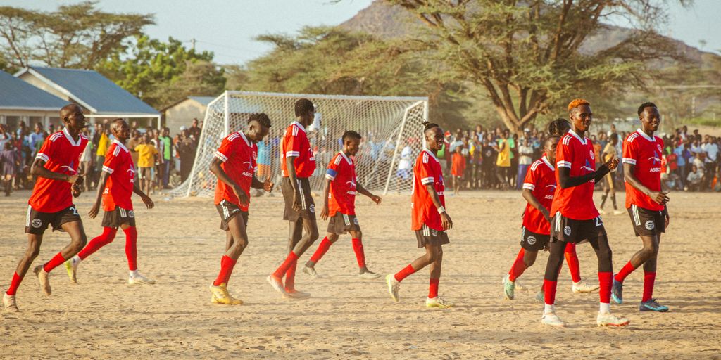 A group of young men playing a game of soccer