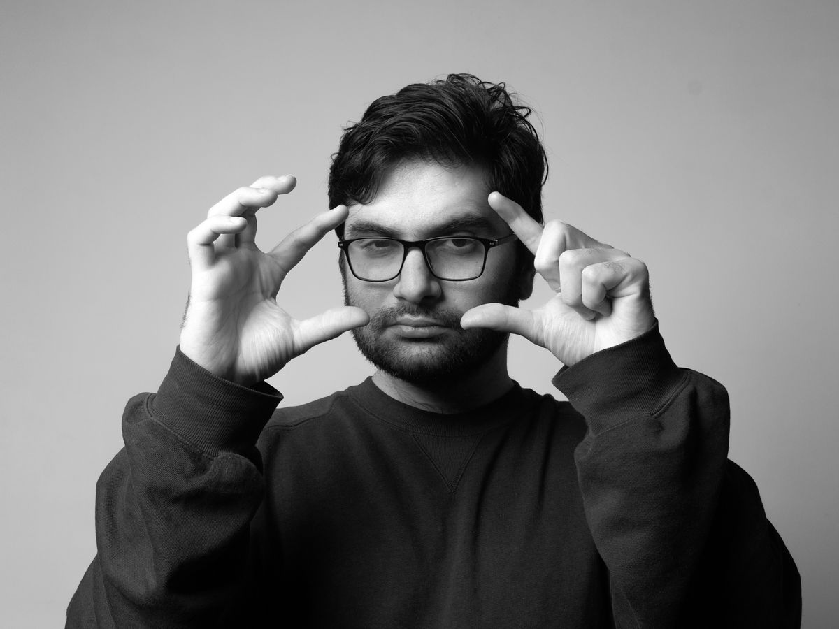 man in black long sleeve shirt wearing black framed eyeglasses