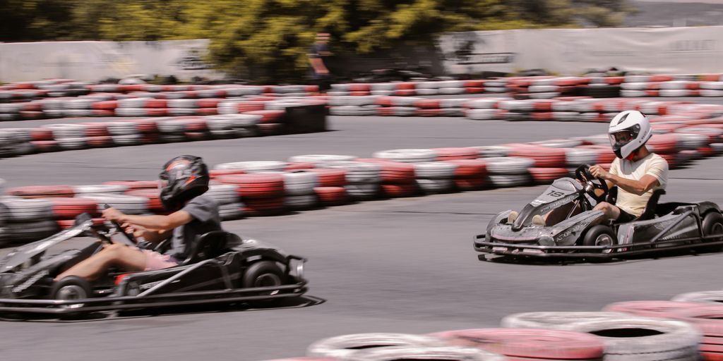 a group of people racing go karts on a track