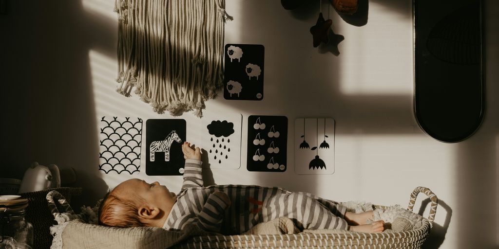 a baby is sleeping in a basket on a table