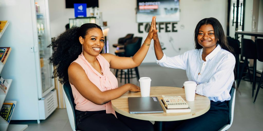 A couple of women sitting at a table