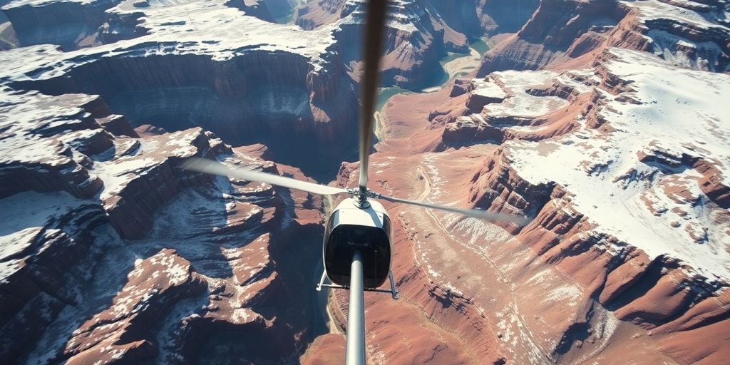 Helicopter flies above a vast, snowy, and rocky canyon.