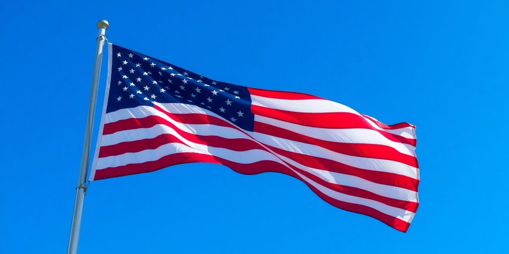 Waving American flag against a blue sky backdrop.