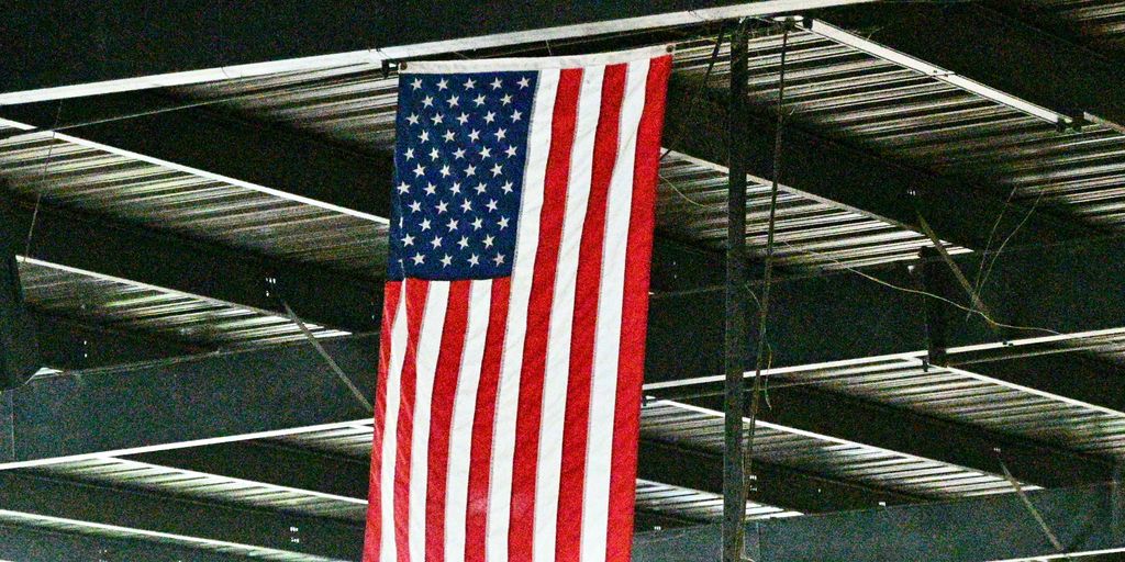 An american flag hanging from the ceiling of a building