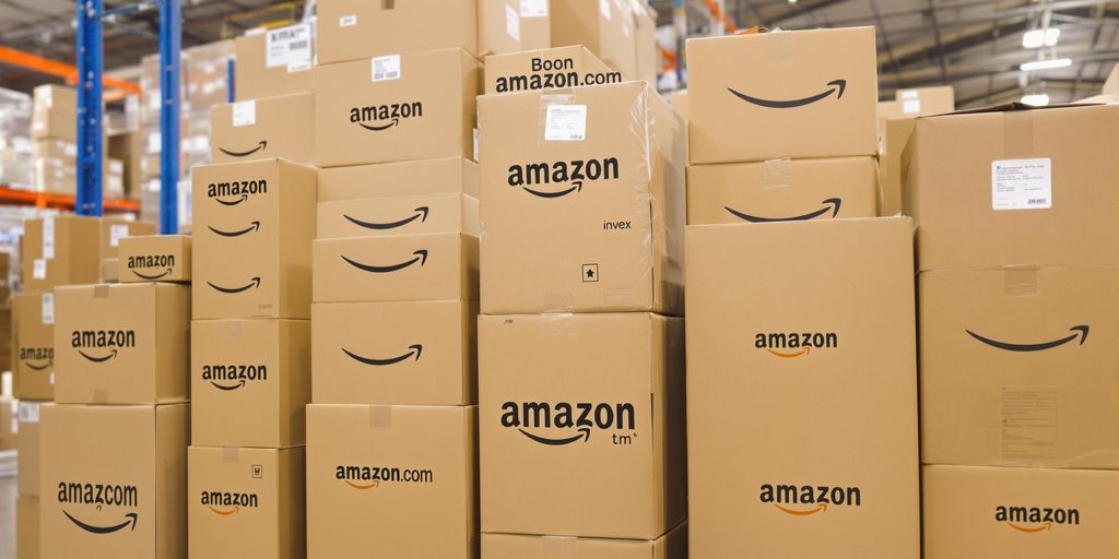 Neatly stacked Amazon inventory boxes in a warehouse.