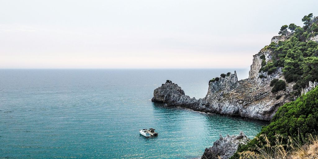 two boats near stone island during day