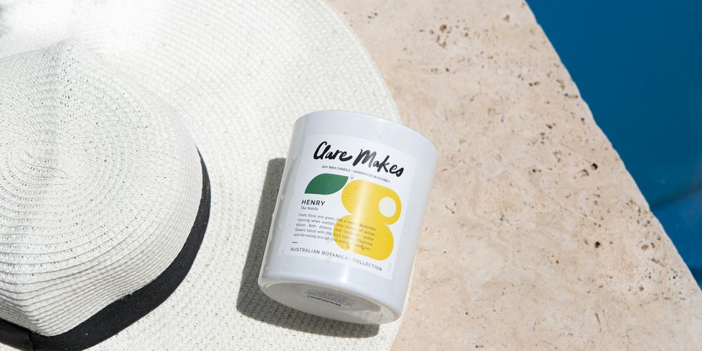 a white hat next to a pool with a jar of sunscreen