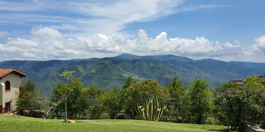 a house on a hill with a view of the mountains