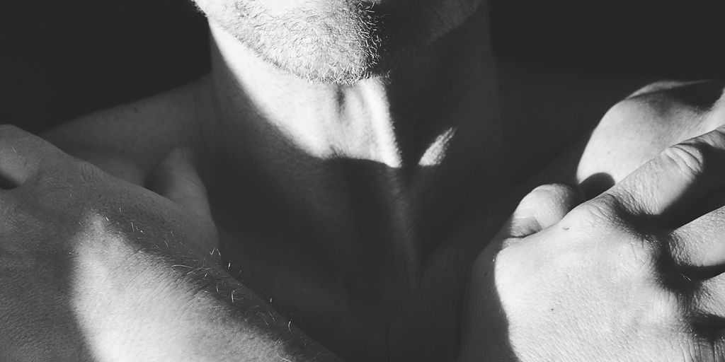 topless man with black background