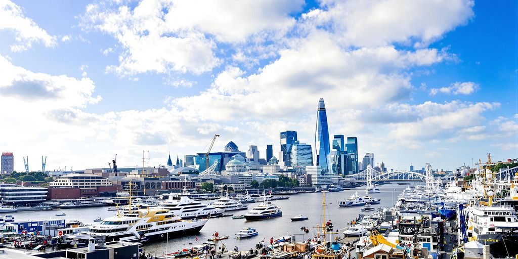 Vibrant London waterfront with ships and iconic skyline.