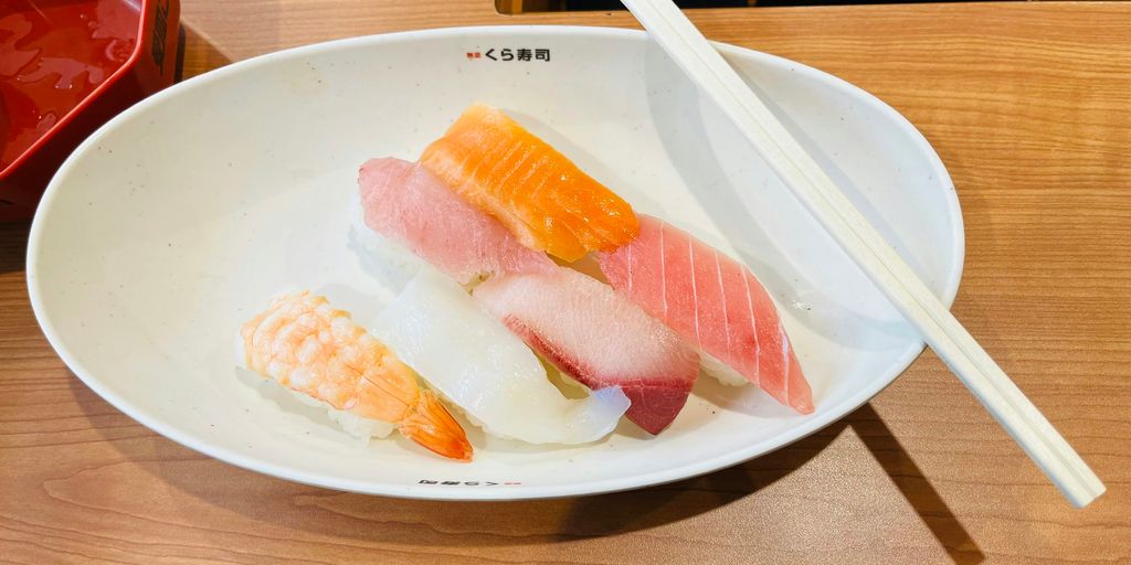A plate of sushi and chopsticks on a table