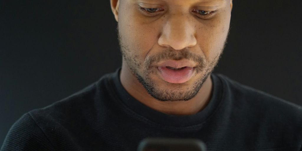 a close up of a person looking at a cell phone