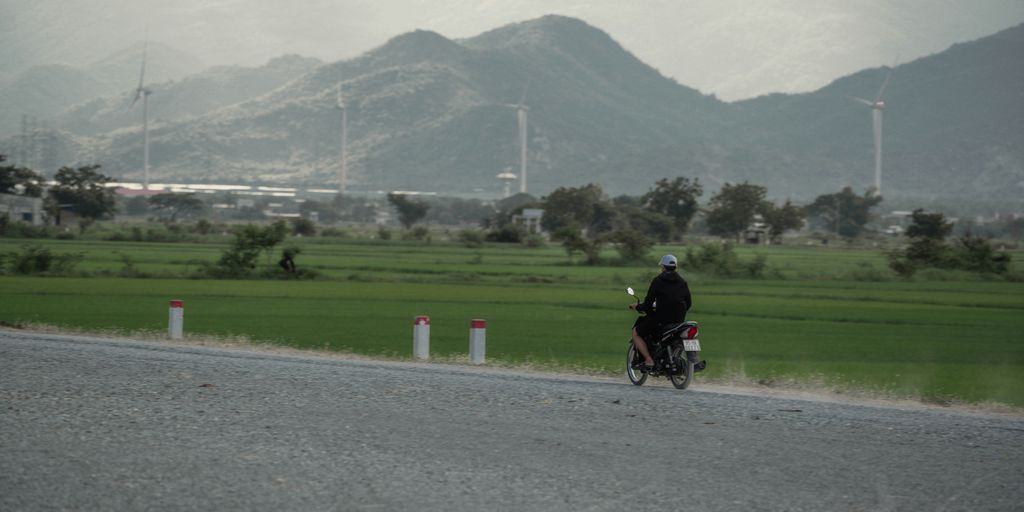man in black shirt riding motorcycle on gray asphalt road during daytime