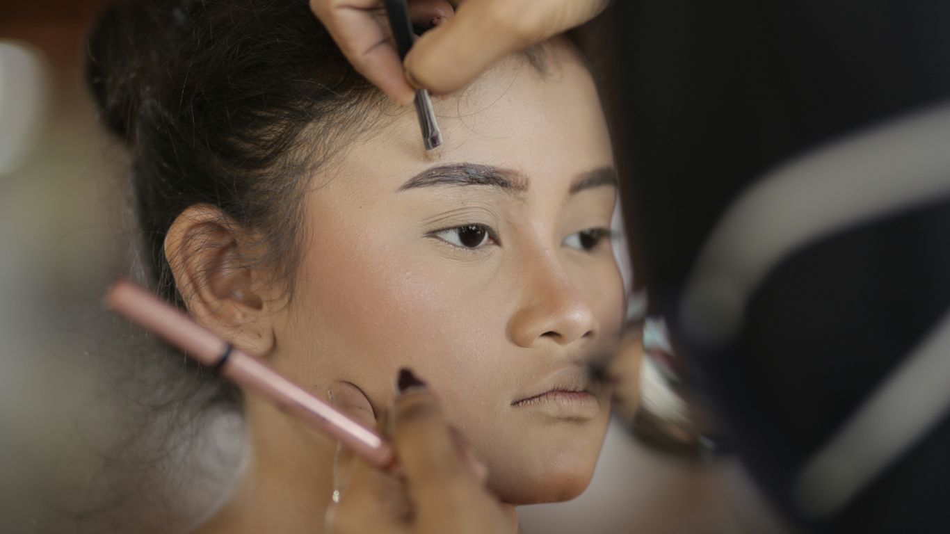 a woman getting her hair done by a professional hair stylist