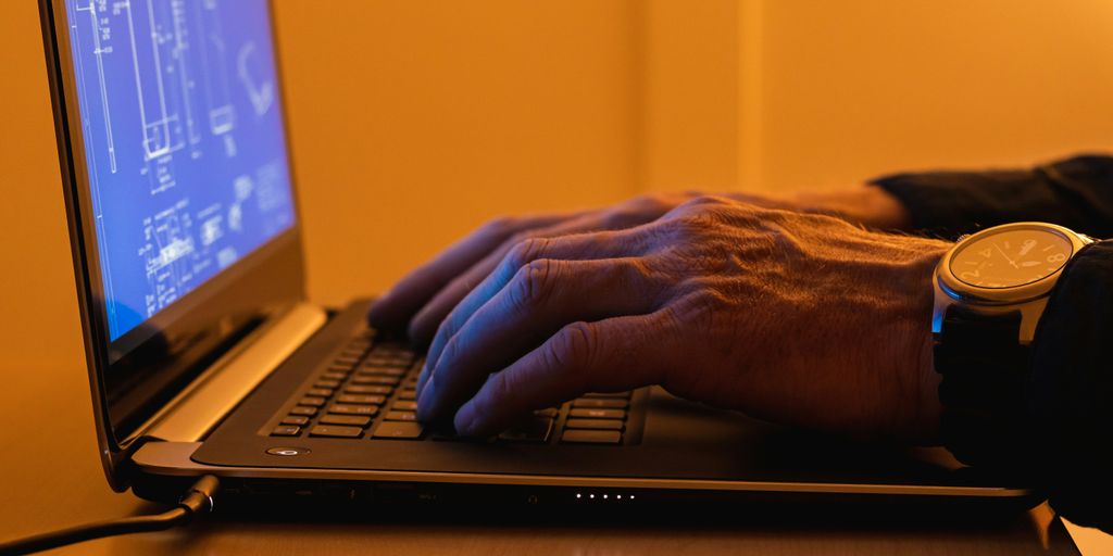 a person using a laptop computer on a desk