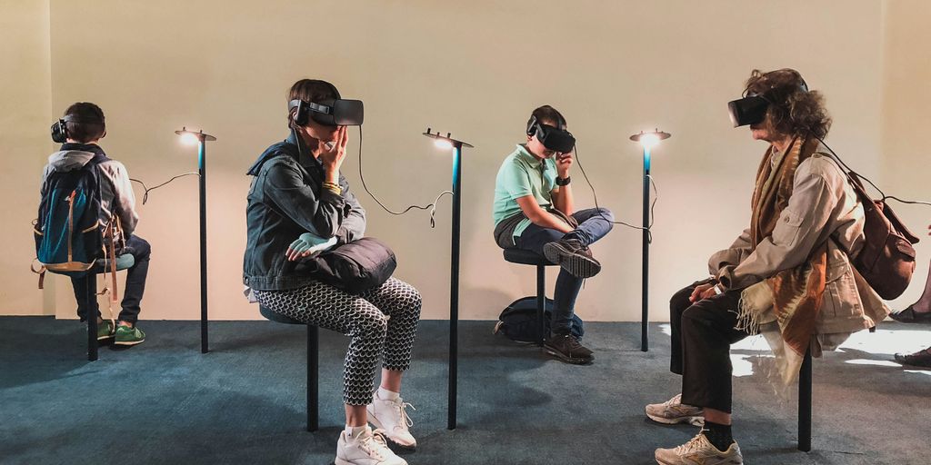 four person playing virtual reality goggles