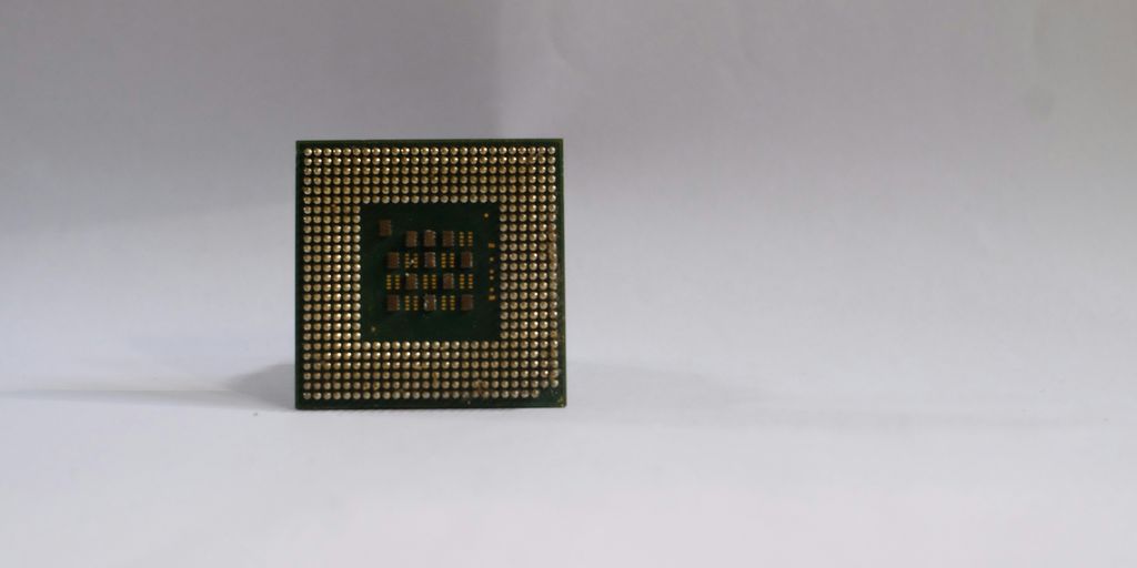 a small square object with a green and black design on it