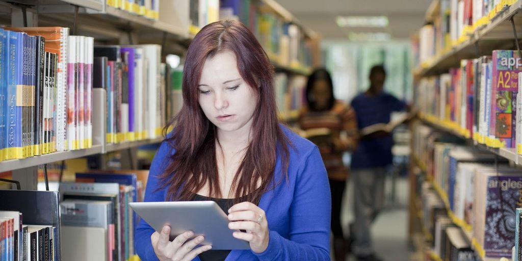 modern classroom with digital devices and students using technology