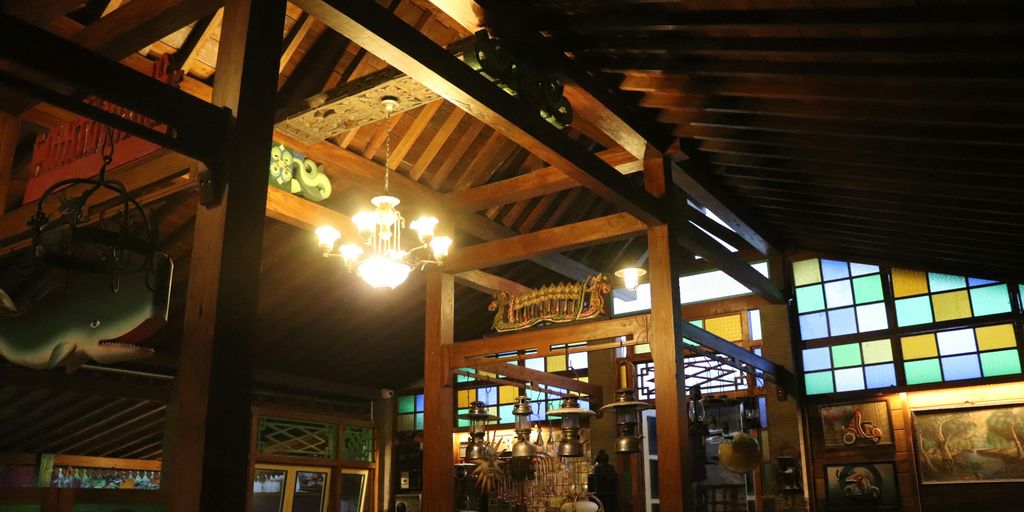 a restaurant with stained glass windows and a wooden ceiling