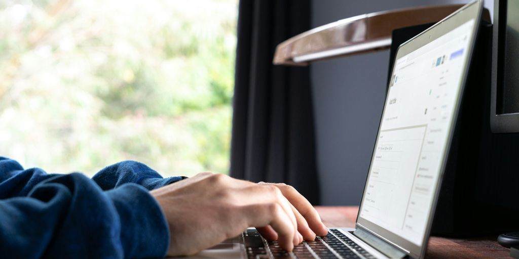 person using macbook pro on table