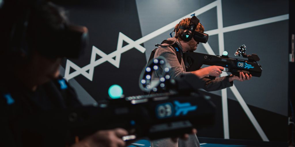 a man with a gun and a video game controller