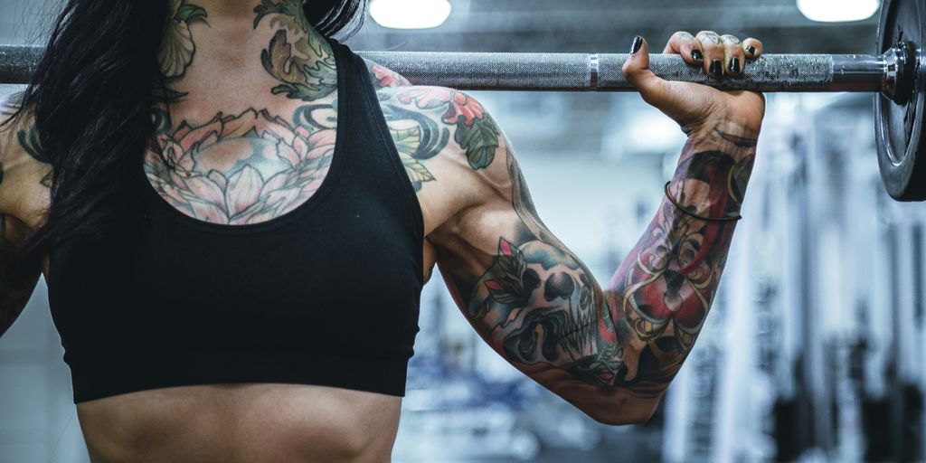 woman carrying barbell