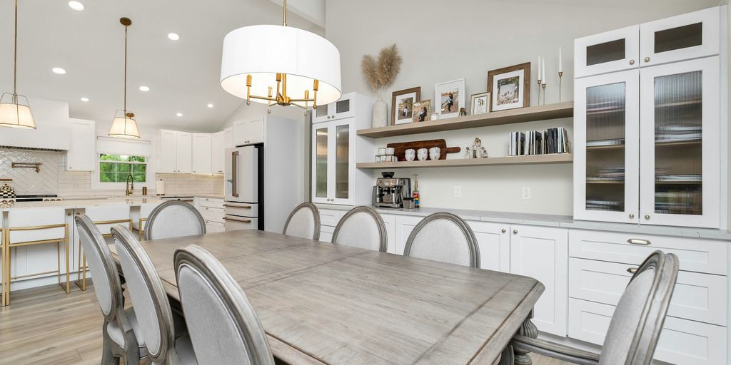 a large kitchen with a table and chairs in it