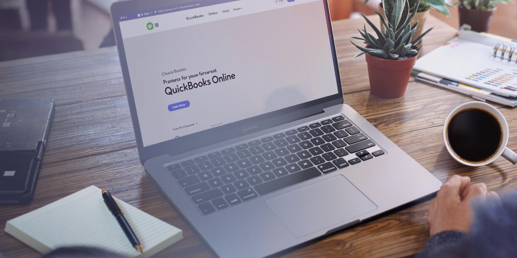 Laptop with QuickBooks Online in a cozy workspace.