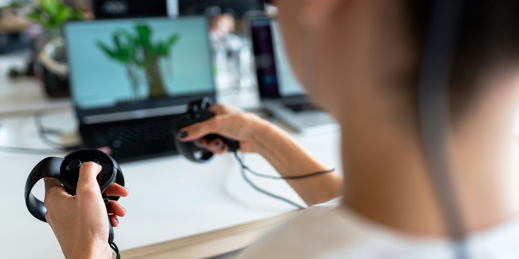 person holding black game controller