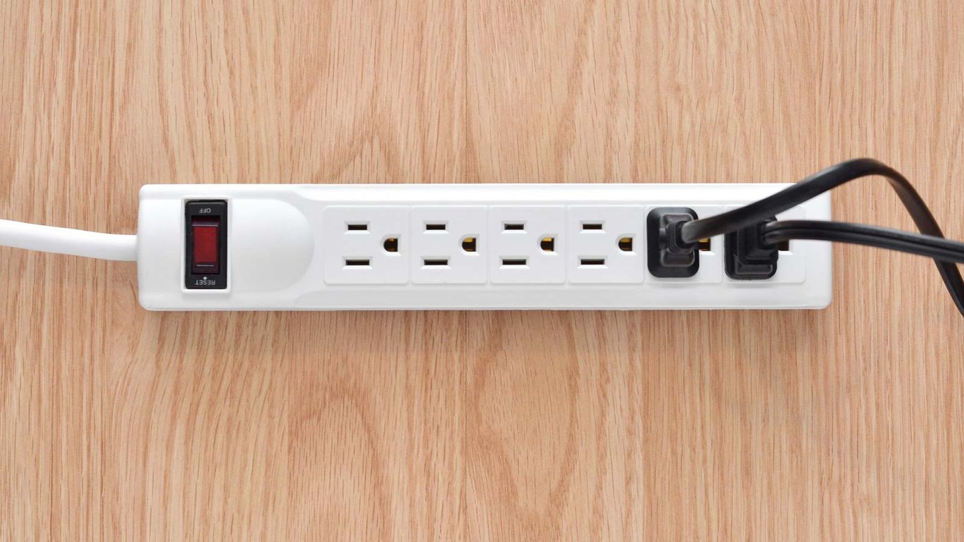 An electrical power strip with multiple outlets and switches.