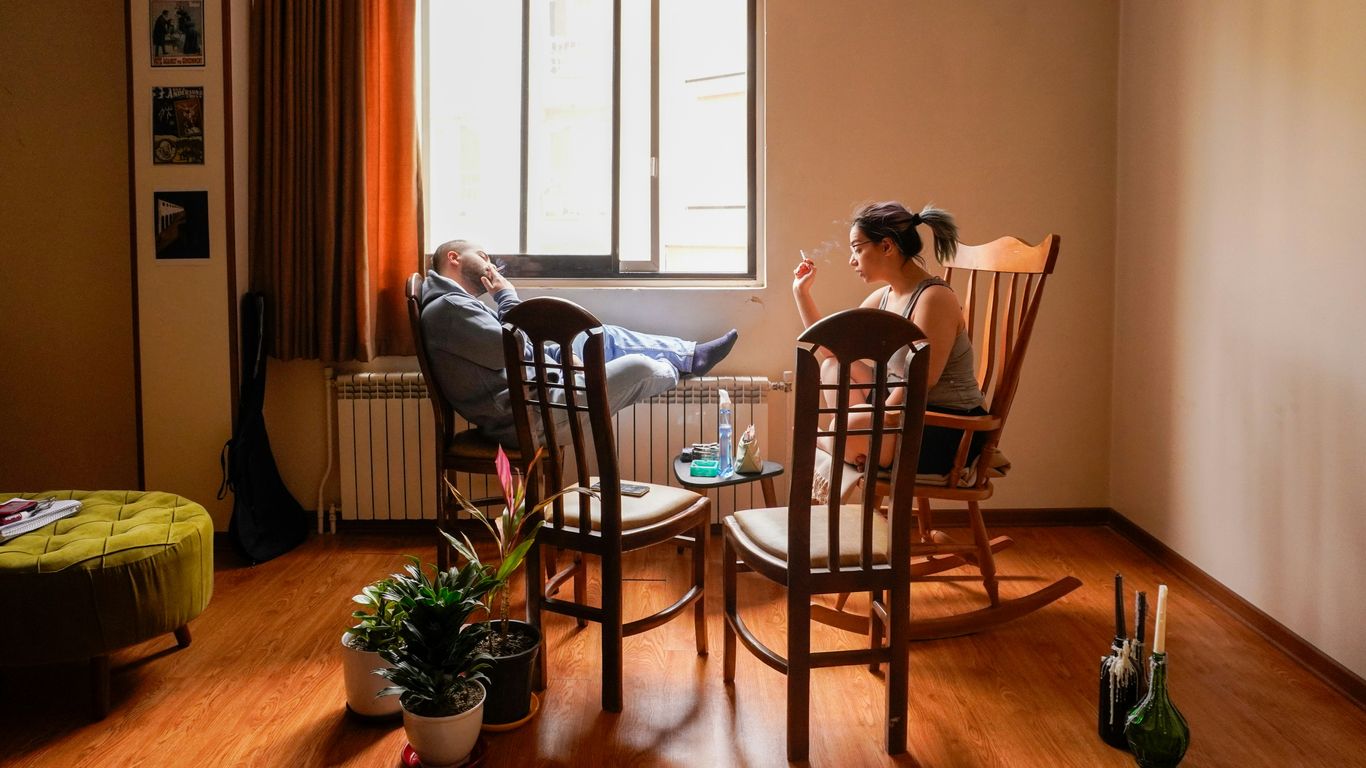 People relax in a cozy living room setting.