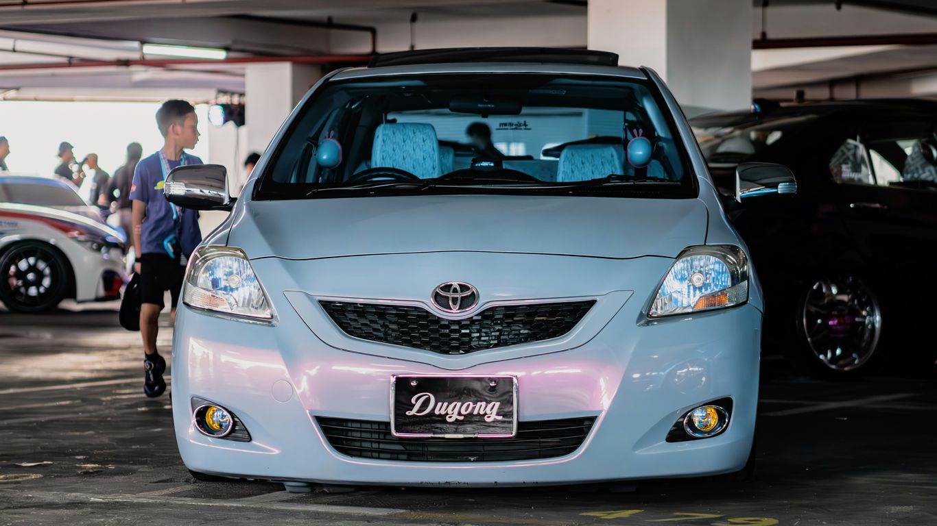 a car parked in a parking garage next to other cars