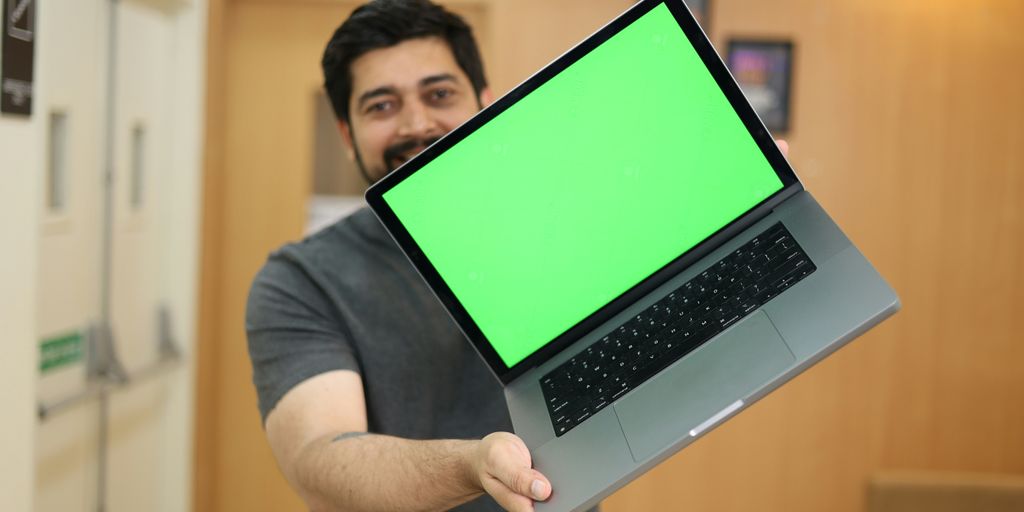 a man holding a laptop