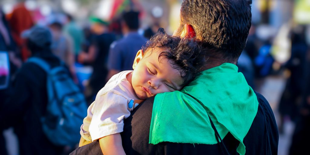 A man carrying a child on his back