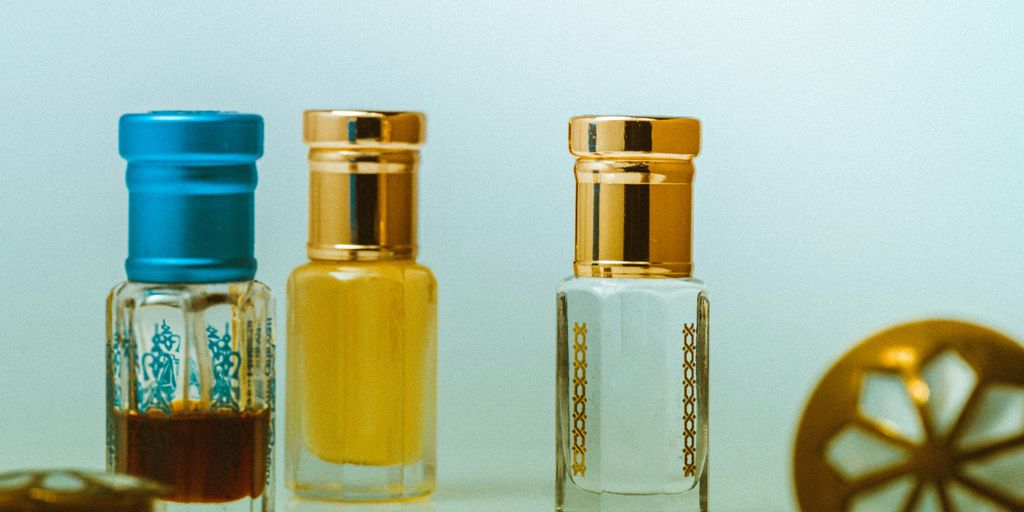 three glass bottles on white table