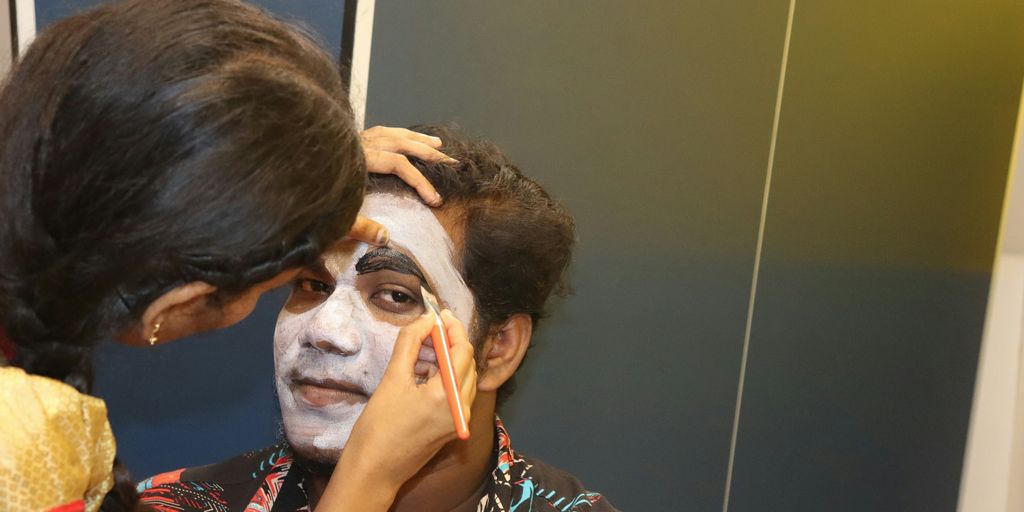 a woman is getting her face painted
