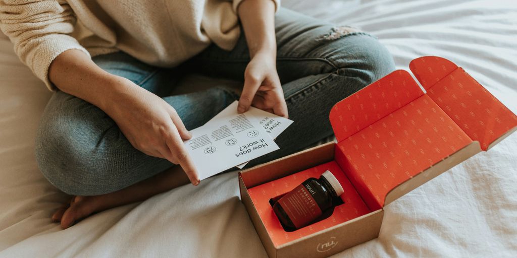 red-labeled amber glass tub on a box