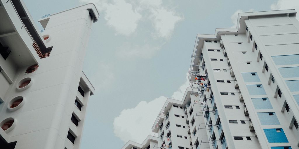 low-angle photo of white building under white sky