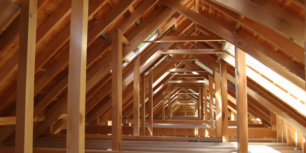 Attic space with clear airflow between rafters.