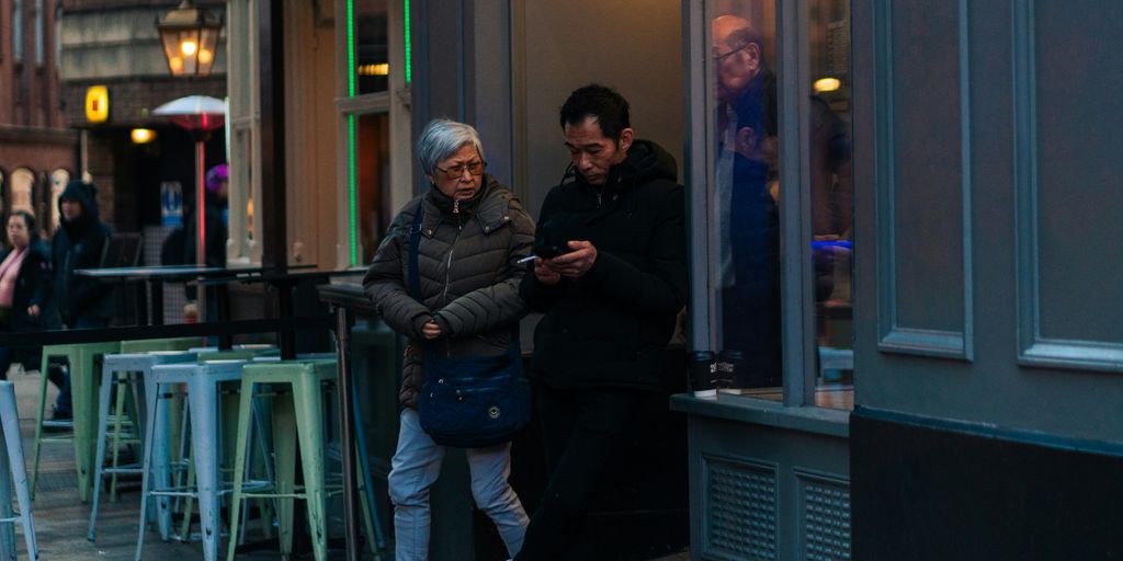 A group of people standing outside of a restaurant