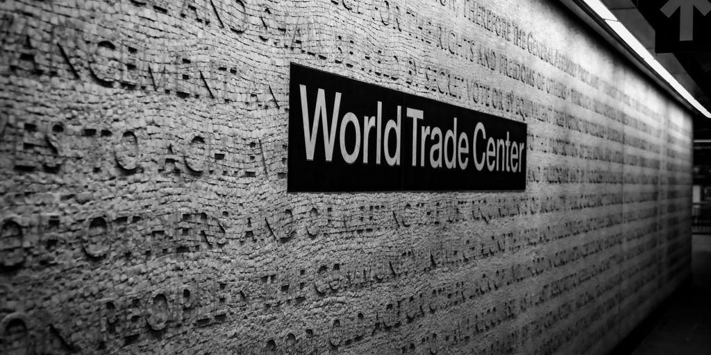 a black and white photo of a world trade center sign